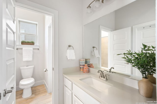 3818 Cualquiera, San Antonio, TX 78261 - bathroom with wood finished floors, toilet, vanity, and baseboards