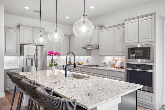 3818 Cualquiera, San Antonio, TX 78261 - kitchen featuring appliances with stainless steel finishes, a sink, backsplash, light stone counters, and recessed lighting