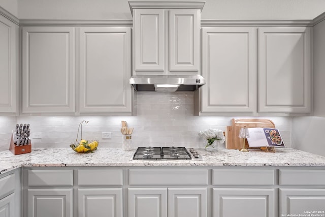 3818 Cualquiera, San Antonio, TX 78261 - kitchen with stainless steel gas cooktop, tasteful backsplash, ventilation hood, and light stone countertops