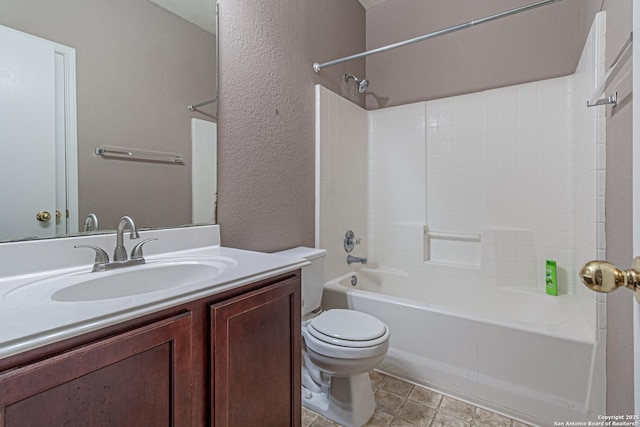 bathroom with toilet, a textured wall, bathtub / shower combination, and vanity
