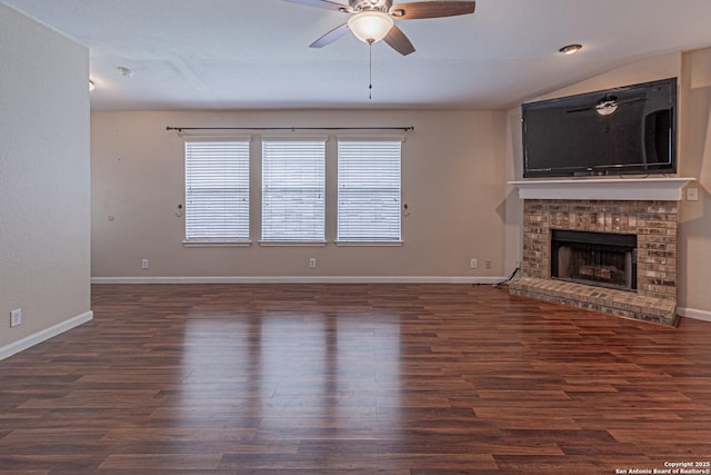 unfurnished living room with wood finished floors, ceiling fan, baseboards, and a fireplace
