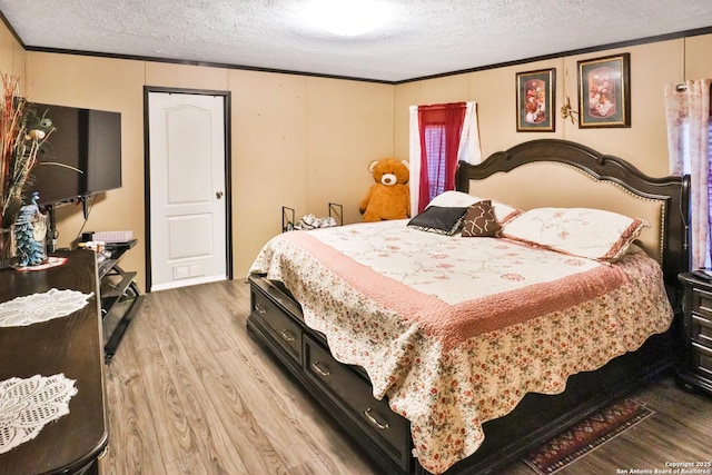 22902 Sweet Liberty, San Antonio, TX 78112 - bedroom with a textured ceiling, ornamental molding, and wood finished floors