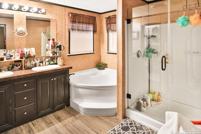 22902 Sweet Liberty, San Antonio, TX 78112 - bathroom with a garden tub, double vanity, wood finished floors, a sink, and a stall shower