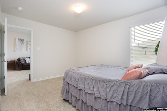 bedroom featuring baseboards and light carpet