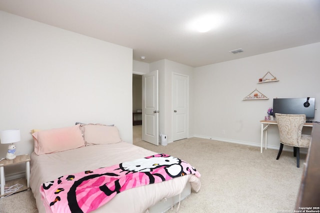 carpeted bedroom with visible vents and baseboards