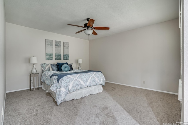 carpeted bedroom with baseboards, a ceiling fan, and a textured ceiling