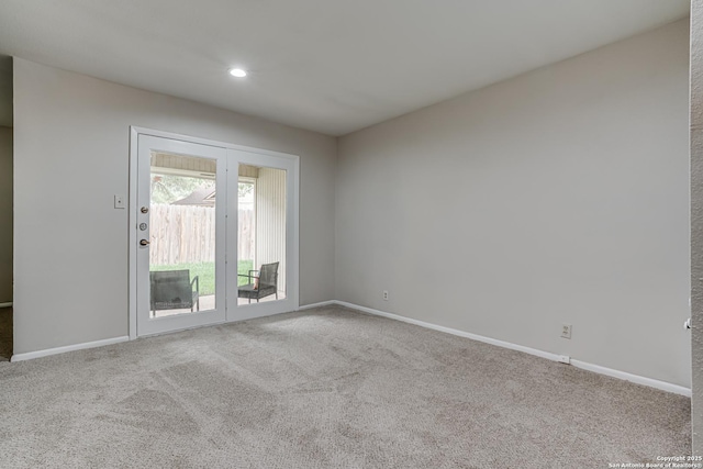 carpeted spare room featuring baseboards and recessed lighting