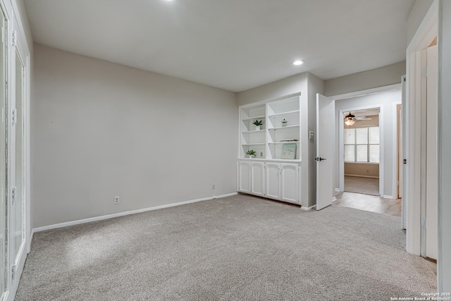 carpeted empty room with baseboards, a ceiling fan, and recessed lighting