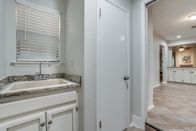bathroom with vanity, baseboards, and visible vents