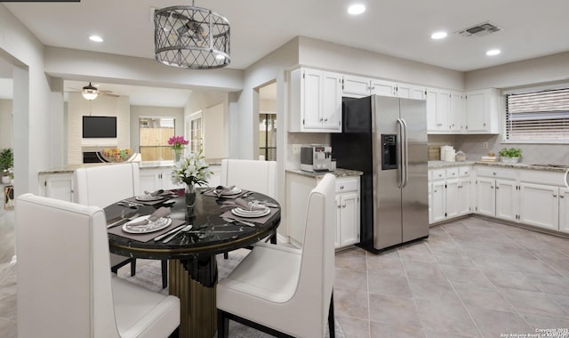 kitchen with white cabinets, a ceiling fan, and stainless steel fridge with ice dispenser