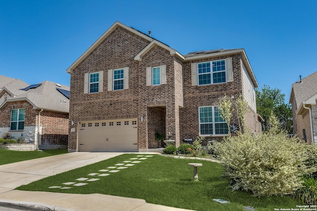 13911 Lazada, San Antonio, TX 78245 - traditional-style house featuring a garage, roof mounted solar panels, a front lawn, brick siding, and driveway
