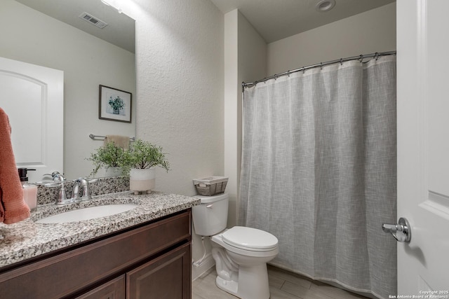 13911 Lazada, San Antonio, TX 78245 - full bath featuring vanity, toilet, and a textured wall