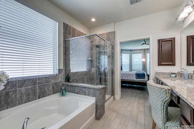 13911 Lazada, San Antonio, TX 78245 - ensuite bathroom with vanity, a bath, a shower stall, and wood finished floors