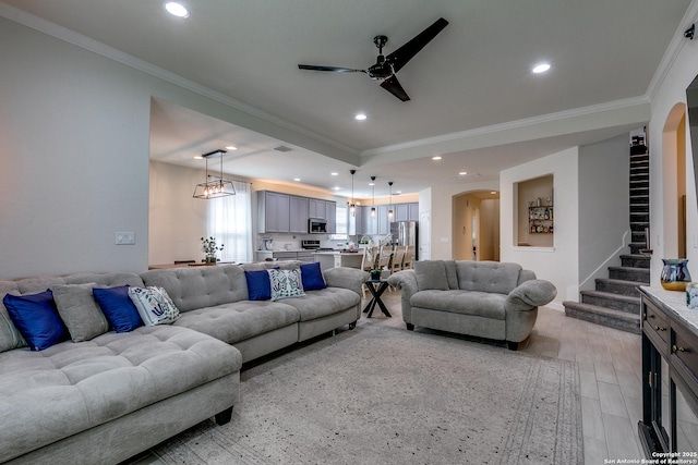 13911 Lazada, San Antonio, TX 78245 - living area with arched walkways, ornamental molding, a ceiling fan, stairs, and recessed lighting