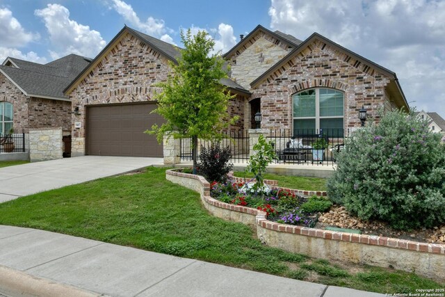 9407 Sundrop Vly, San Antonio, TX 78254 - french provincial home with fence, stone siding, brick siding, an attached garage, and driveway