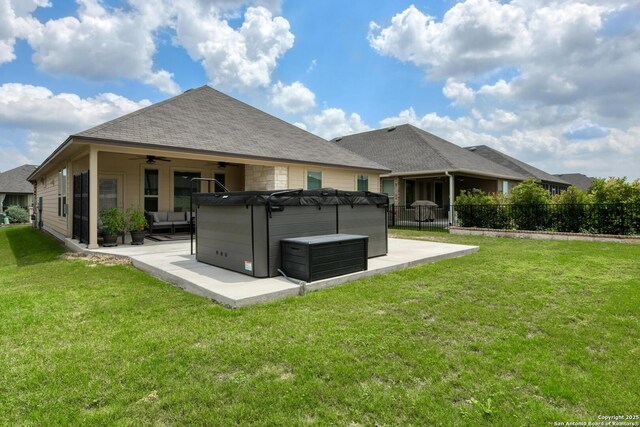 9407 Sundrop Vly, San Antonio, TX 78254 - back of property featuring a hot tub, a patio, ceiling fan, and a yard