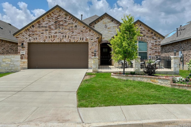 9407 Sundrop Vly, San Antonio, TX 78254 - french country home with an attached garage, a front yard, stone siding, and concrete driveway