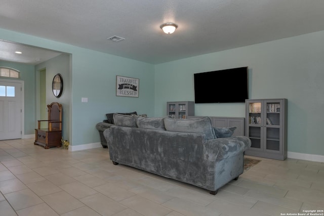 9407 Sundrop Vly, San Antonio, TX 78254 - living area with light tile patterned floors, baseboards, and visible vents
