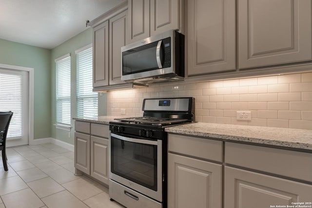 9407 Sundrop Vly, San Antonio, TX 78254 - kitchen with appliances with stainless steel finishes, gray cabinets, baseboards, and backsplash