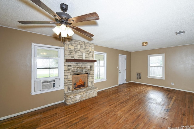 1304 Landa, New Braunfels, TX 78132 - unfurnished living room featuring visible vents, wood finished floors, baseboards, a textured ceiling, and cooling unit