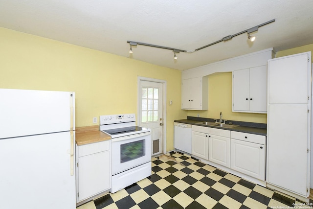 1304 Landa, New Braunfels, TX 78132 - kitchen with rail lighting, a sink, light floors, white appliances, and white cabinetry