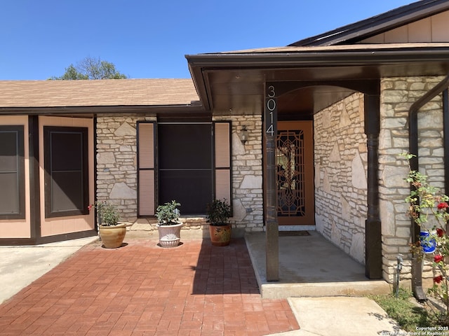 3014 War Knife, San Antonio, TX 78238 - property entrance featuring a shingled roof, board and batten siding, and stone siding