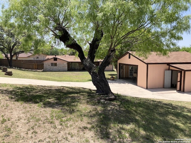 3014 War Knife, San Antonio, TX 78238 - view of front of house with fence, a patio, a garage, and a front yard