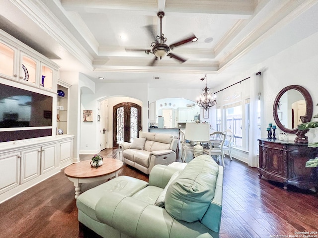 living room featuring a healthy amount of sunlight, arched walkways, coffered ceiling, and ceiling fan with notable chandelier