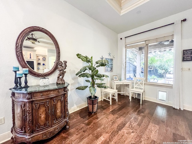 sitting room featuring crown molding, baseboards, vaulted ceiling, and dark wood-style floors