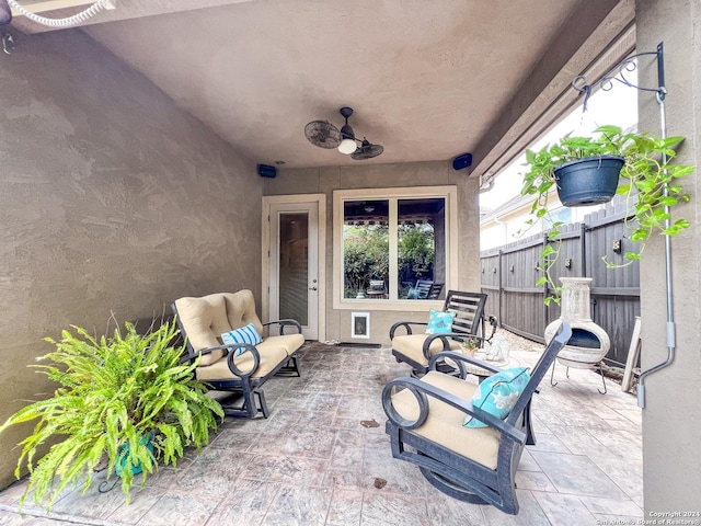 view of patio featuring fence and ceiling fan