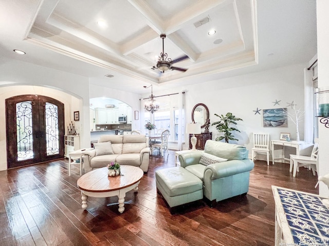 living area featuring a notable chandelier, arched walkways, french doors, visible vents, and coffered ceiling