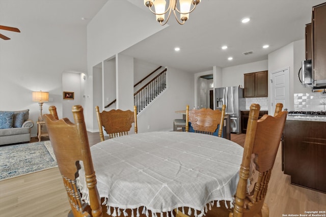 12819 Canadian, San Antonio, TX 78253 - dining area featuring light wood-style flooring, ceiling fan with notable chandelier, recessed lighting, visible vents, and stairway