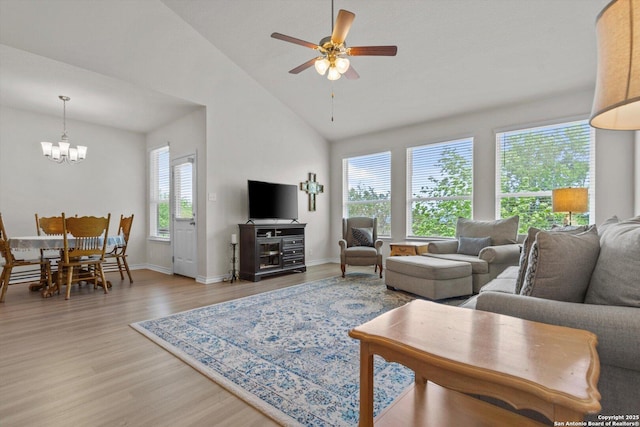 12819 Canadian, San Antonio, TX 78253 - living room with light wood-style floors, baseboards, ceiling fan with notable chandelier, and high vaulted ceiling