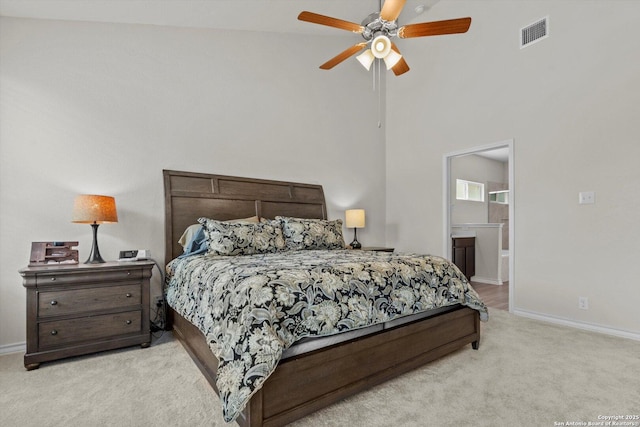 12819 Canadian, San Antonio, TX 78253 - bedroom with visible vents, light carpet, baseboards, ensuite bathroom, and a high ceiling