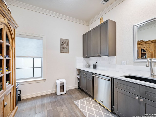 4 Waterford Gln, San Antonio, TX 78257 - kitchen featuring a sink, stainless steel dishwasher, gray cabinets, ornamental molding, and light wood-type flooring
