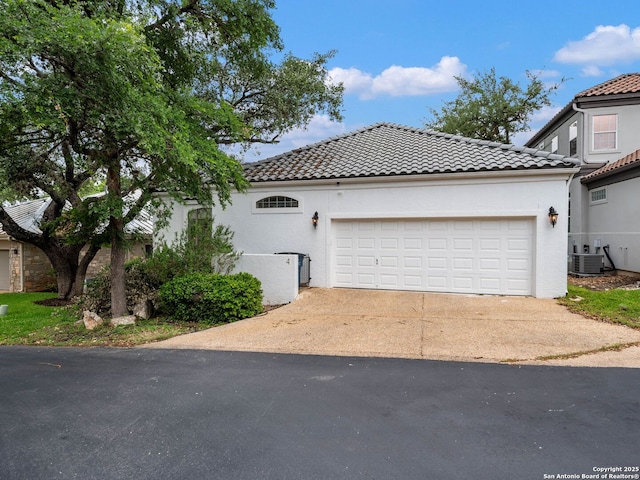 4 Waterford Gln, San Antonio, TX 78257 - mediterranean / spanish-style home with a tile roof, driveway, a garage, cooling unit, and stucco siding