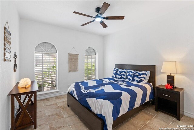 bedroom featuring baseboards and ceiling fan