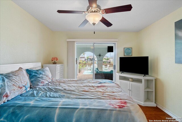 bedroom featuring ceiling fan, baseboards, access to outside, and wood finished floors
