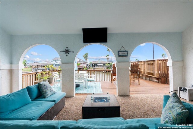 view of patio / terrace featuring an outdoor living space with a fire pit, a wooden deck, and outdoor dining space