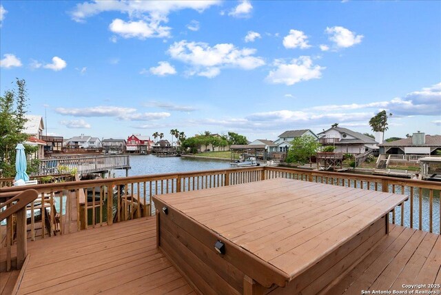 dock area featuring a deck with water view and a residential view