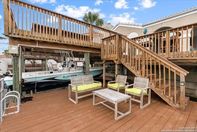 wooden deck with a dock and stairs