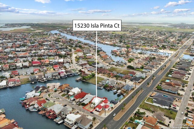 drone / aerial view with a residential view and a water view