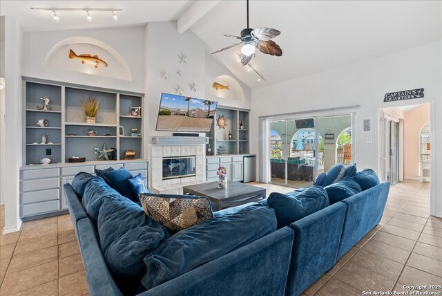 tiled living area featuring ceiling fan, built in features, a fireplace, high vaulted ceiling, and beamed ceiling