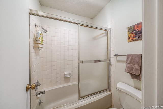 full bath with toilet and bath / shower combo with glass door