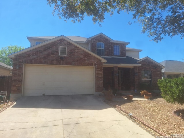 traditional-style home with a garage, concrete driveway, a porch, and brick siding