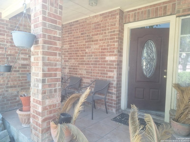 entrance to property with brick siding