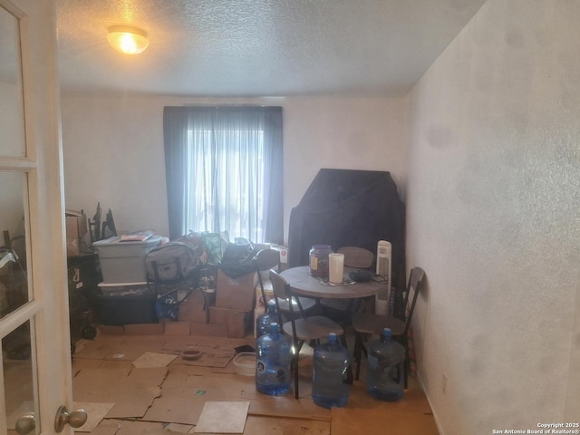 dining space featuring a textured ceiling