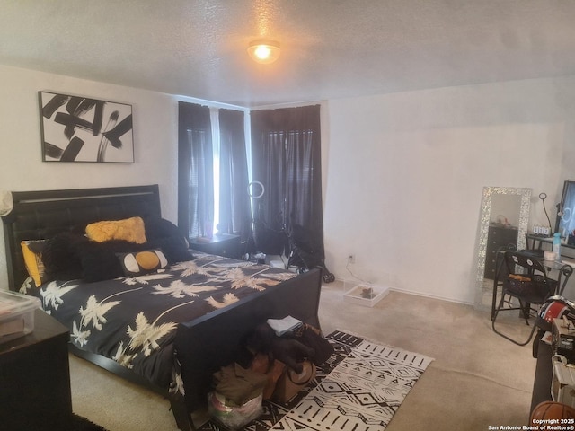 carpeted bedroom featuring a textured ceiling