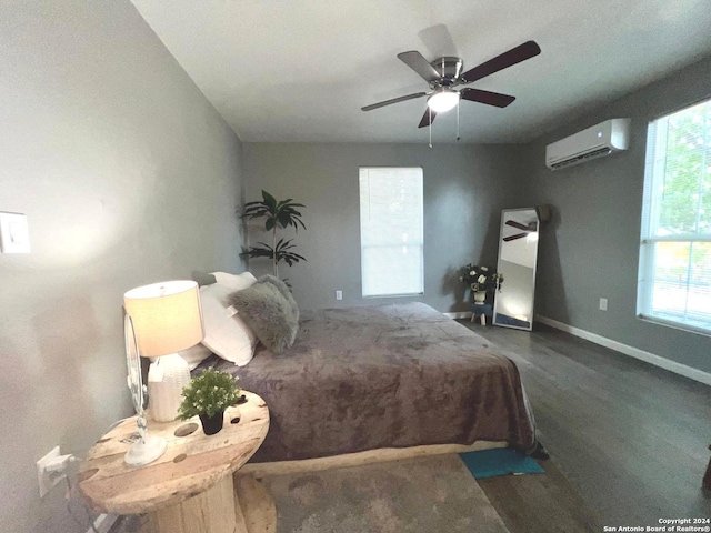 bedroom with ceiling fan, multiple windows, wood finished floors, and a wall mounted air conditioner
