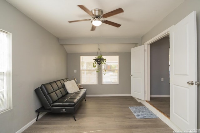 sitting room with baseboards, a ceiling fan, wood finished floors, and lofted ceiling